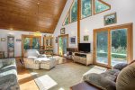 Open living with soaring ceilings and surrounding sliders